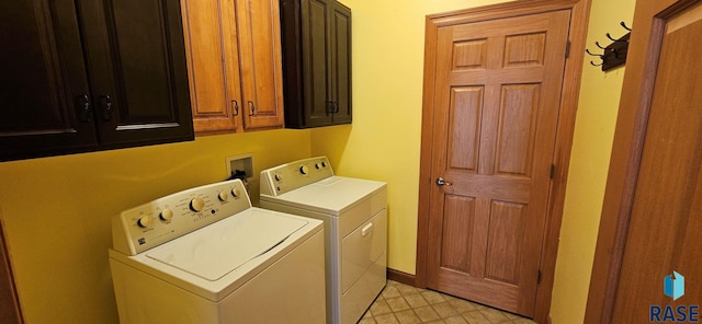 851 Regency Ct, Brookings, SD 57006 - clothes washing area with washer and clothes dryer, cabinet space, and light tile patterned flooring
