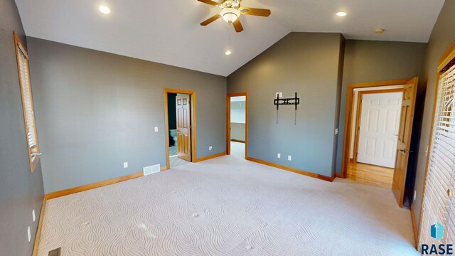 851 Regency Ct, Brookings, SD 57006 - unfurnished bedroom featuring light carpet, baseboards, vaulted ceiling, recessed lighting, and a walk in closet