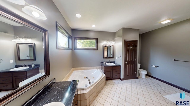 851 Regency Ct, Brookings, SD 57006 - full bathroom featuring a whirlpool tub, tile patterned flooring, two vanities, toilet, and baseboards