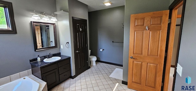 851 Regency Ct, Brookings, SD 57006 - full bath featuring toilet, tile patterned floors, vanity, and a tub to relax in