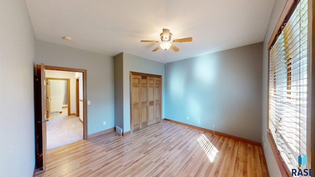 851 Regency Ct, Brookings, SD 57006 - unfurnished bedroom featuring light wood finished floors, baseboards, and a closet