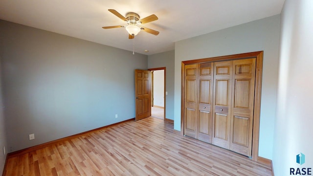 851 Regency Ct, Brookings, SD 57006 - unfurnished bedroom with light wood-style flooring, baseboards, a closet, and ceiling fan