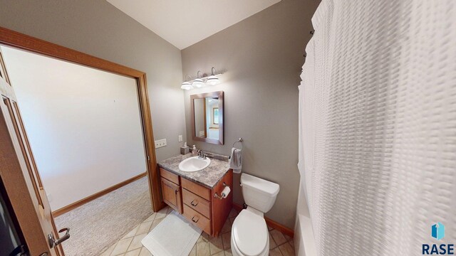 851 Regency Ct, Brookings, SD 57006 - full bath with toilet, vanity, a shower with shower curtain, tile patterned floors, and baseboards