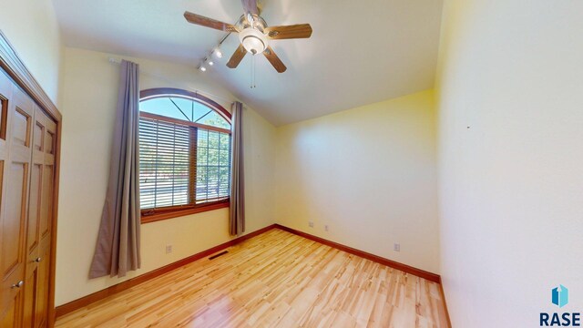 851 Regency Ct, Brookings, SD 57006 - spare room with light wood-style flooring, vaulted ceiling, baseboards, and ceiling fan