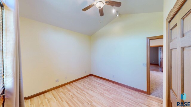 851 Regency Ct, Brookings, SD 57006 - empty room with vaulted ceiling, ceiling fan, light wood finished floors, baseboards, and track lighting