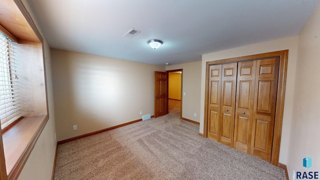 851 Regency Ct, Brookings, SD 57006 - unfurnished bedroom with carpet flooring, baseboards, and a closet