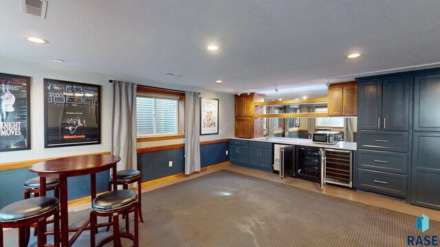 851 Regency Ct, Brookings, SD 57006 - bar featuring wine cooler, recessed lighting, and stainless steel microwave