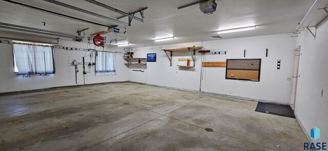 851 Regency Ct, Brookings, SD 57006 - garage with a garage door opener and baseboards