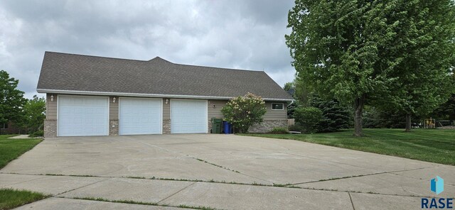 851 Regency Ct, Brookings, SD 57006 - view of side of home with a yard and roof with shingles