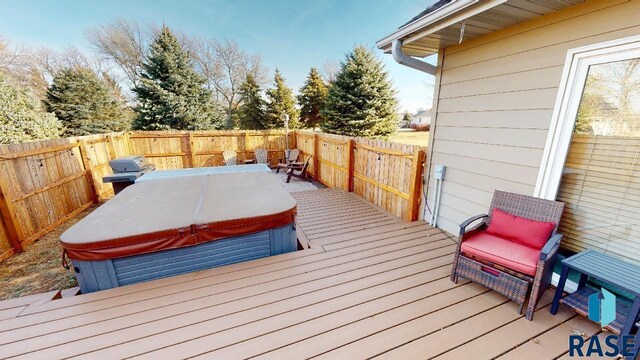 851 Regency Ct, Brookings, SD 57006 - wooden terrace with a covered hot tub, a fenced backyard, and grilling area