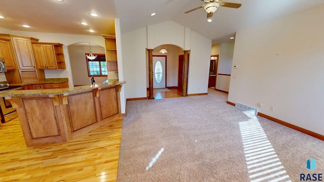 851 Regency Ct, Brookings, SD 57006 - kitchen with open shelves, arched walkways, electric range, a kitchen bar, and ceiling fan