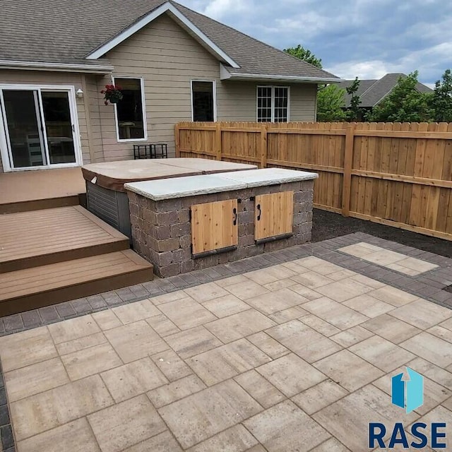 851 Regency Ct, Brookings, SD 57006 - view of patio / terrace with a hot tub, fence, and a deck
