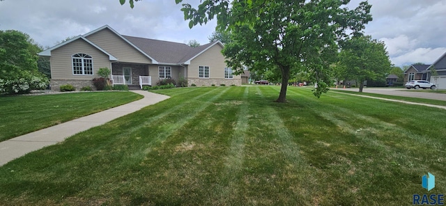 851 Regency Ct, Brookings, SD 57006 - ranch-style house with a front lawn and stone siding