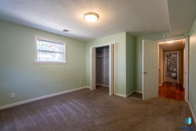 3105 S Lyndale Ave, Sioux Falls, SD 57105 - unfurnished bedroom featuring dark carpet, a textured ceiling, baseboards, and a closet