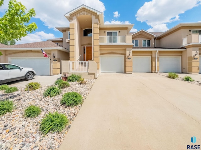 5918 S Grand Lodge Pl, Sioux Falls, SD 57108 - view of front of house featuring stucco siding, driveway, a garage, and a balcony