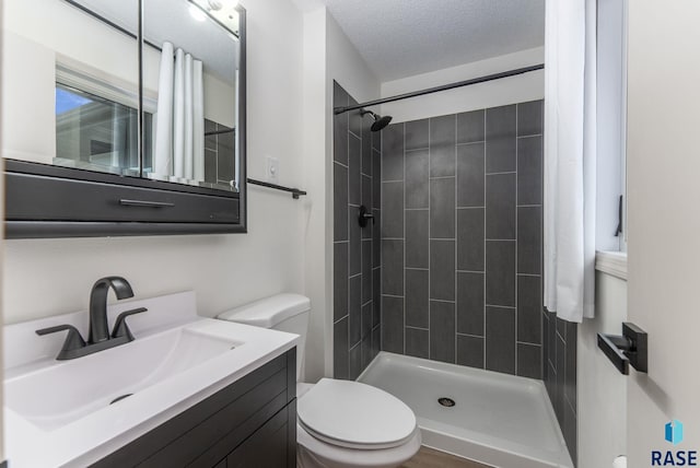 1335 Blue Ox St, Harrisburg, SD 57032 - full bath featuring toilet, tiled shower, vanity, and a textured ceiling