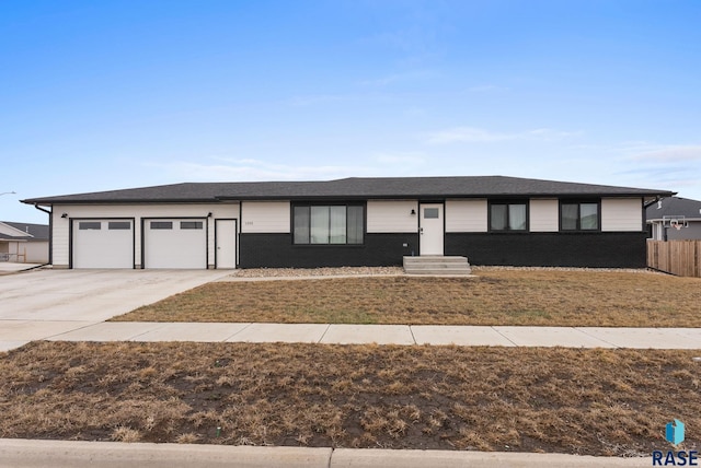 1335 Blue Ox St, Harrisburg, SD 57032 - single story home featuring concrete driveway, an attached garage, fence, and brick siding