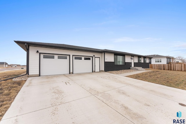 1335 Blue Ox St, Harrisburg, SD 57032 - view of front of property with concrete driveway, a garage, and fence