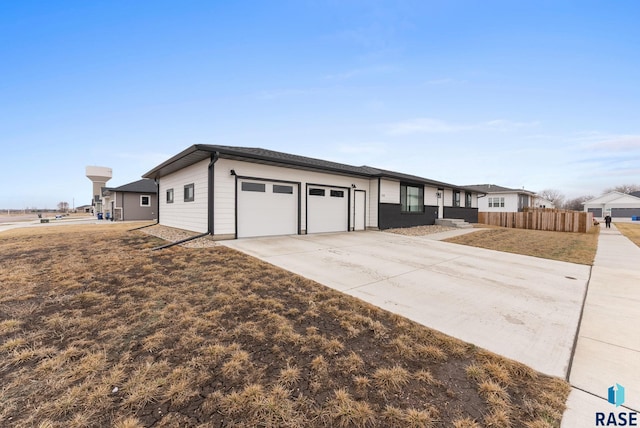 1335 Blue Ox St, Harrisburg, SD 57032 - view of front of house with an attached garage, driveway, and fence
