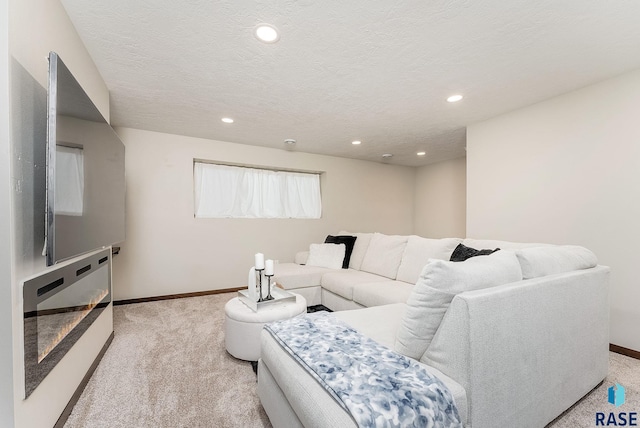 living room featuring light carpet, baseboards, recessed lighting, and a textured ceiling