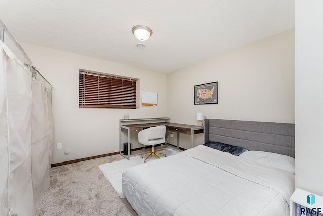 bedroom with carpet floors and baseboards