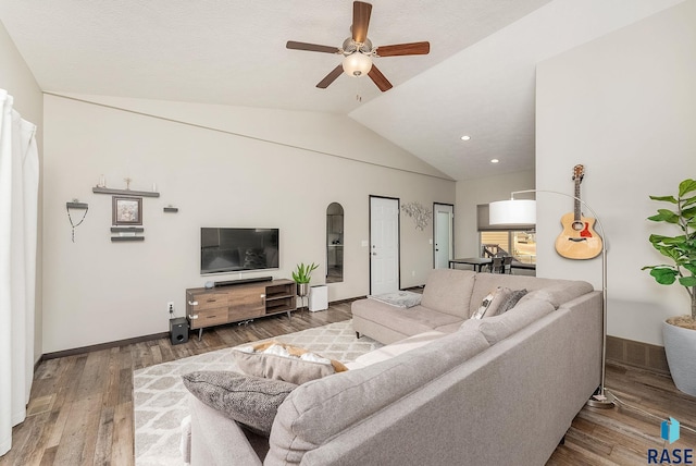 living room featuring hardwood / wood-style flooring, a ceiling fan, vaulted ceiling, baseboards, and recessed lighting