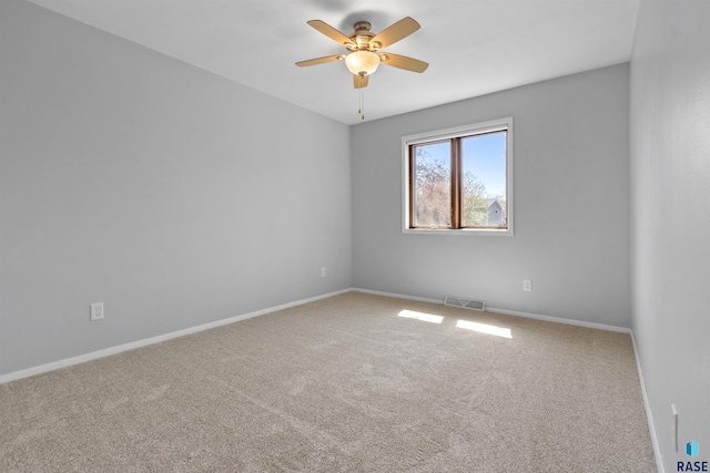 empty room featuring carpet floors, ceiling fan, and baseboards