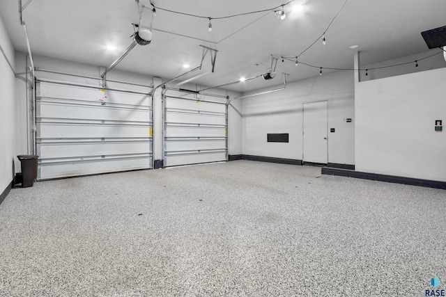 garage featuring a garage door opener and baseboards