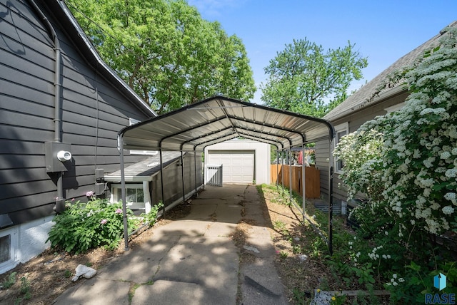 view of vehicle parking featuring concrete driveway, fence, and a detached carport