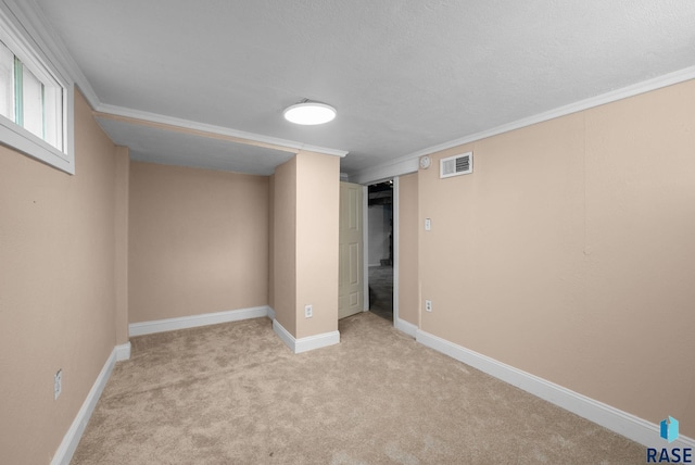 below grade area with crown molding, carpet flooring, and baseboards
