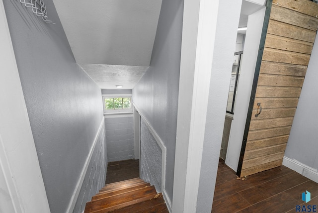 stairway featuring hardwood / wood-style flooring and baseboards