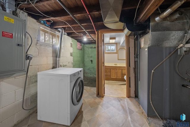below grade area with washer / clothes dryer, electric panel, and healthy amount of natural light