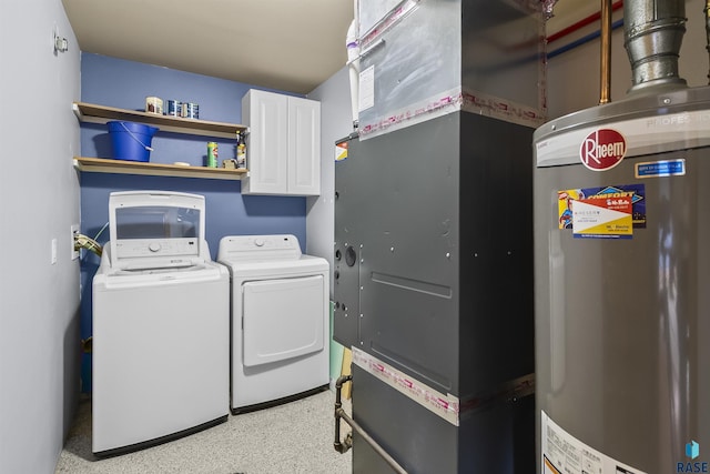 laundry area with water heater, washing machine and dryer, heating unit, and cabinet space