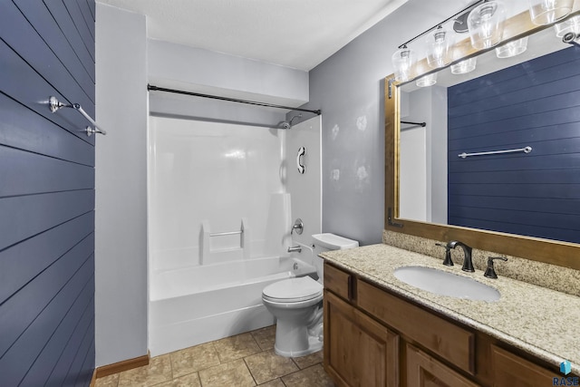 bathroom featuring toilet, vanity, and  shower combination
