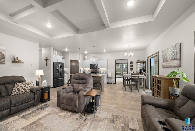 living room featuring a chandelier, light wood-style flooring, recessed lighting, beamed ceiling, and coffered ceiling