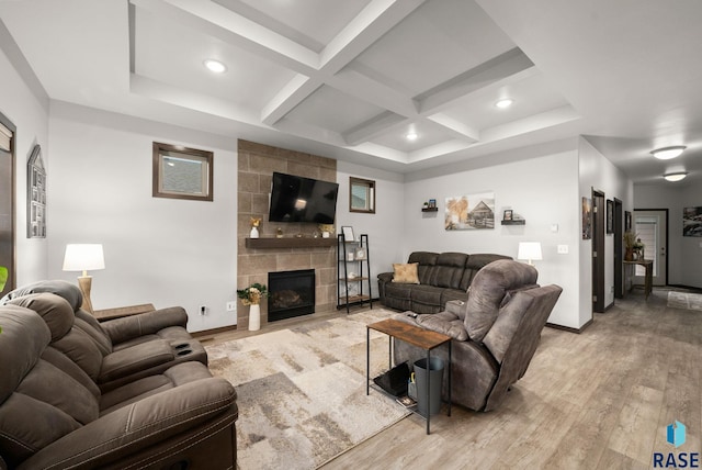 living area featuring light wood finished floors, coffered ceiling, beam ceiling, baseboards, and a fireplace