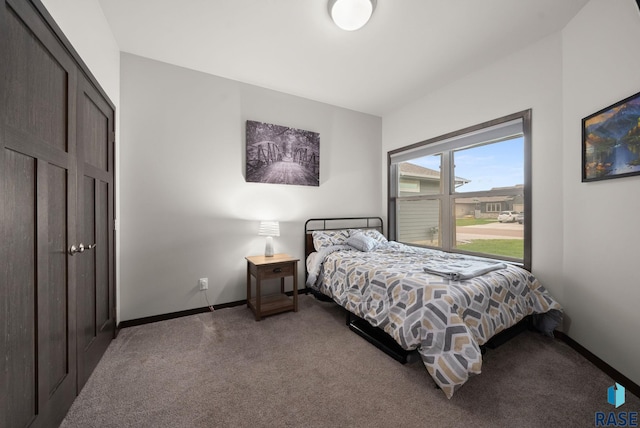 bedroom with carpet floors and baseboards