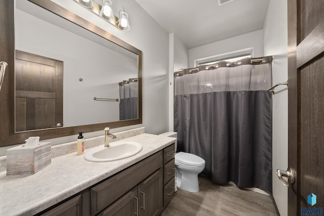full bath with wood finished floors, vanity, toilet, and a shower with curtain