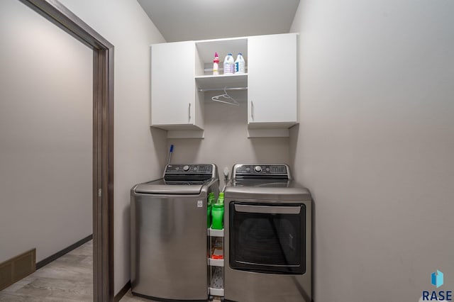 laundry room featuring cabinet space and independent washer and dryer