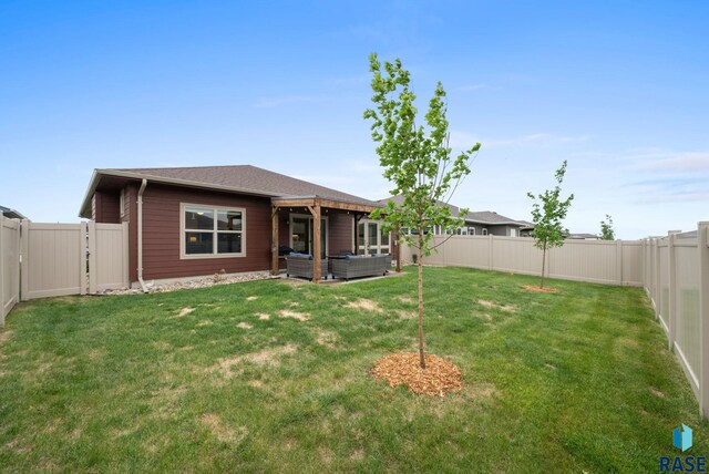 rear view of house featuring an outdoor living space and a gate