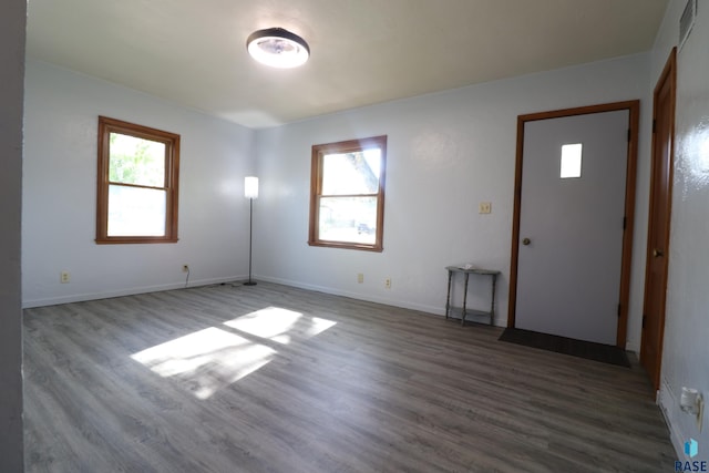 unfurnished room with wood finished floors and baseboards
