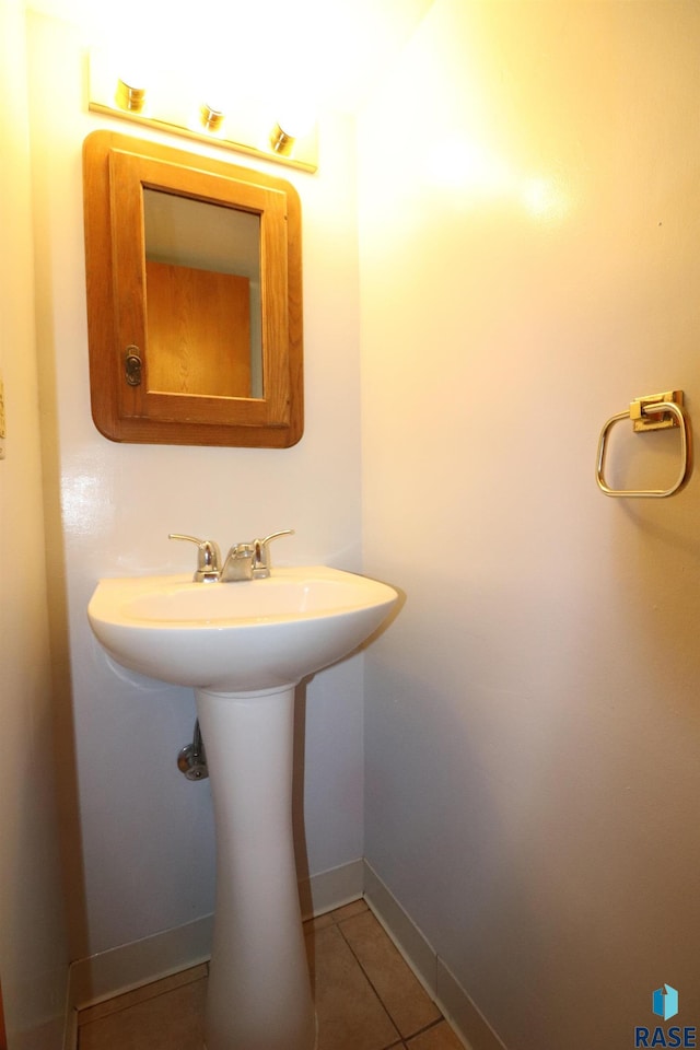 bathroom with tile patterned floors and baseboards