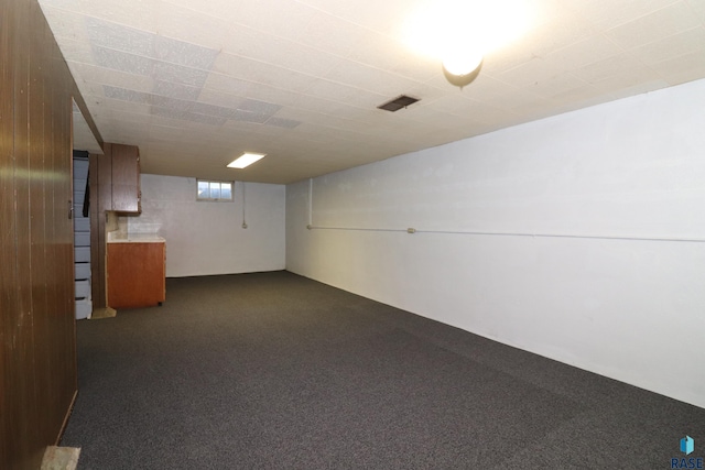 below grade area featuring dark carpet