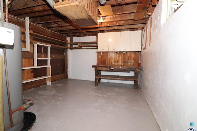 unfinished basement featuring gas water heater