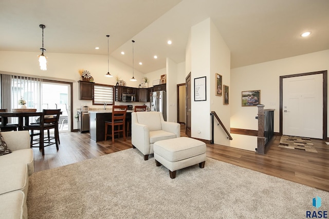 812 Trojan Ave, Hartford, SD 57033 - living room featuring wood finished floors, recessed lighting, high vaulted ceiling, and baseboards