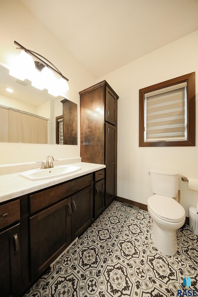 812 Trojan Ave, Hartford, SD 57033 - bathroom with toilet, vanity, baseboards, and tile patterned flooring
