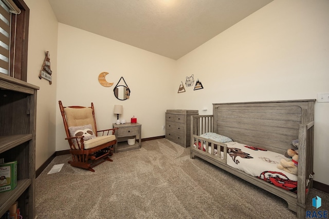 812 Trojan Ave, Hartford, SD 57033 - carpeted bedroom with lofted ceiling, a crib, and baseboards