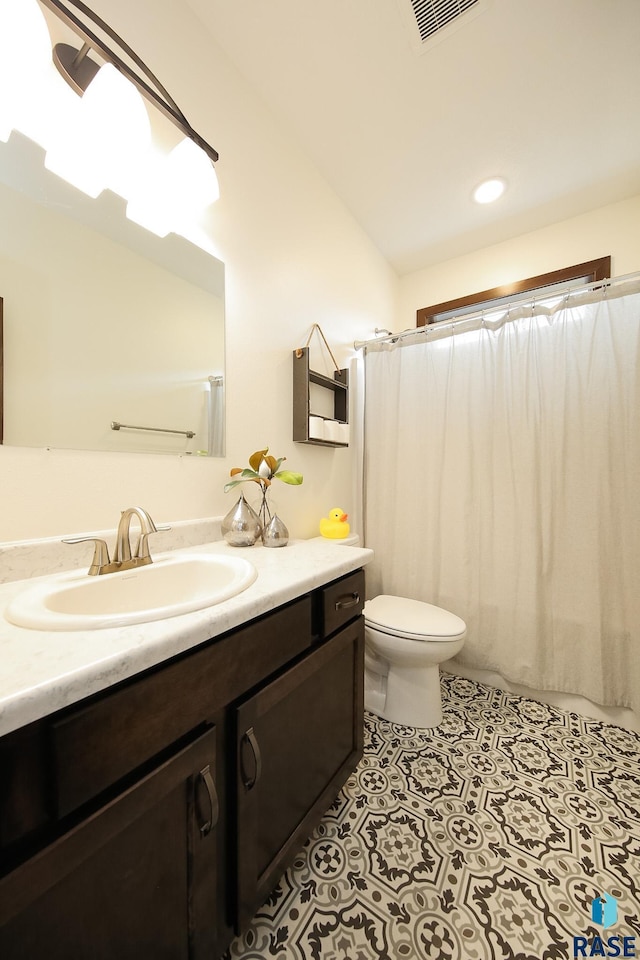 812 Trojan Ave, Hartford, SD 57033 - full bath with vanity, toilet, a shower with shower curtain, tile patterned floors, and recessed lighting