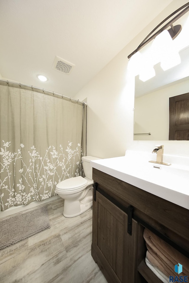 812 Trojan Ave, Hartford, SD 57033 - full bath featuring toilet, vanity, wood finished floors, and a shower with curtain