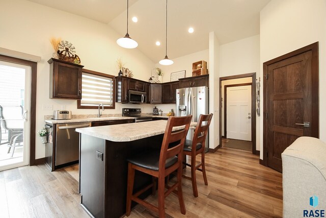 812 Trojan Ave, Hartford, SD 57033 - kitchen with appliances with stainless steel finishes, dark brown cabinets, light countertops, light wood finished floors, and lofted ceiling